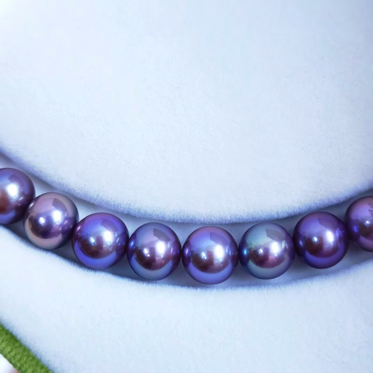 Close-up of natural deep purple Edison freshwater pearls with very high luster
