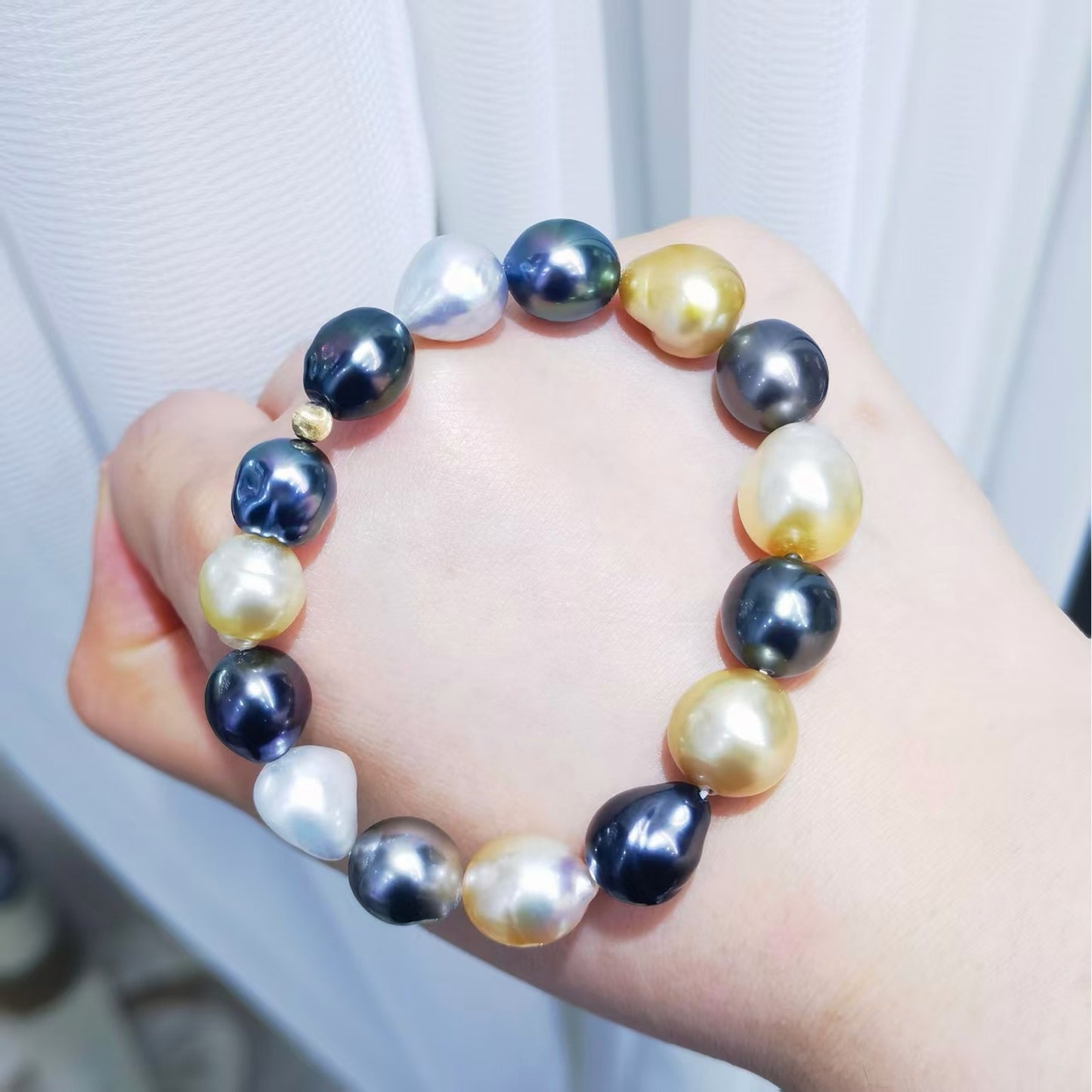 Mixed South Sea and Tahitian baroque pearl bracelet shown on wrist with plump baroque pearls