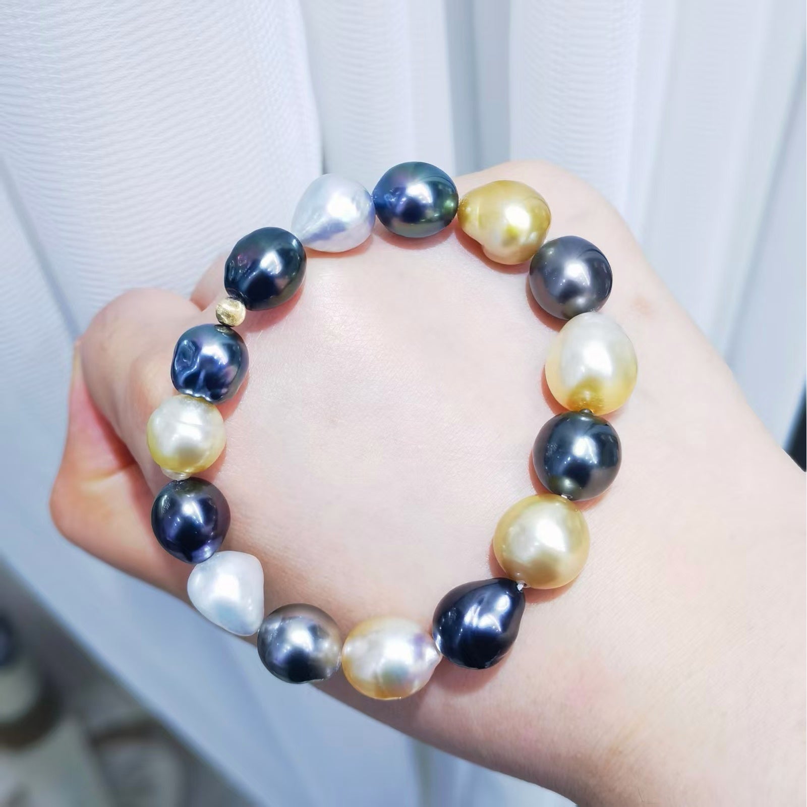 Mixed South Sea and Tahitian baroque pearl bracelet shown on wrist with plump baroque pearls