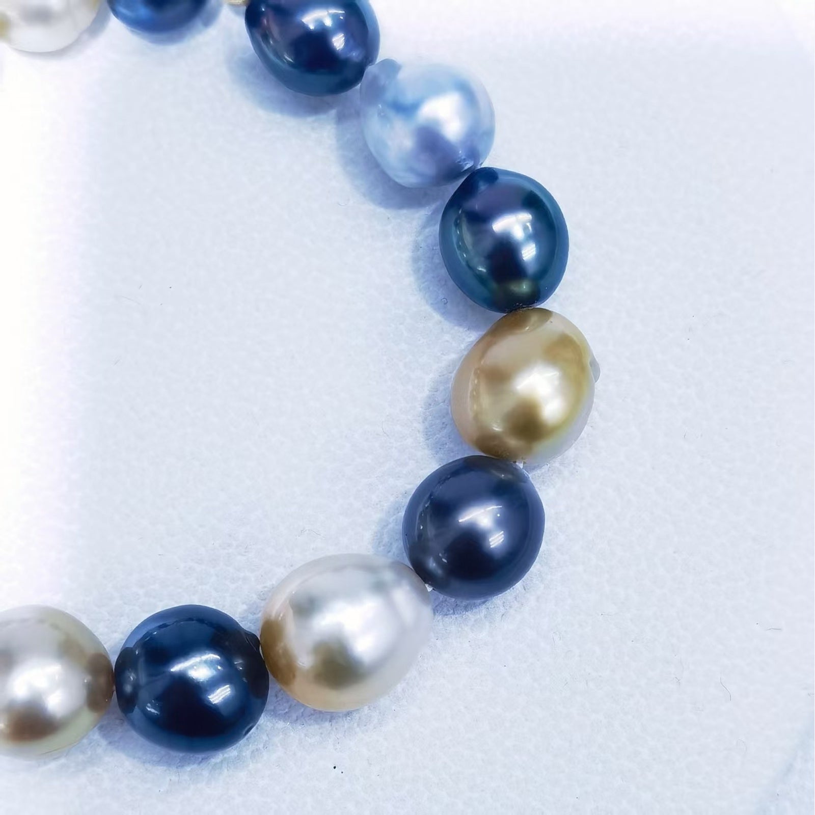 Close-up of mixed South Sea and Tahitian baroque pearls showing luster, shape, and surface character