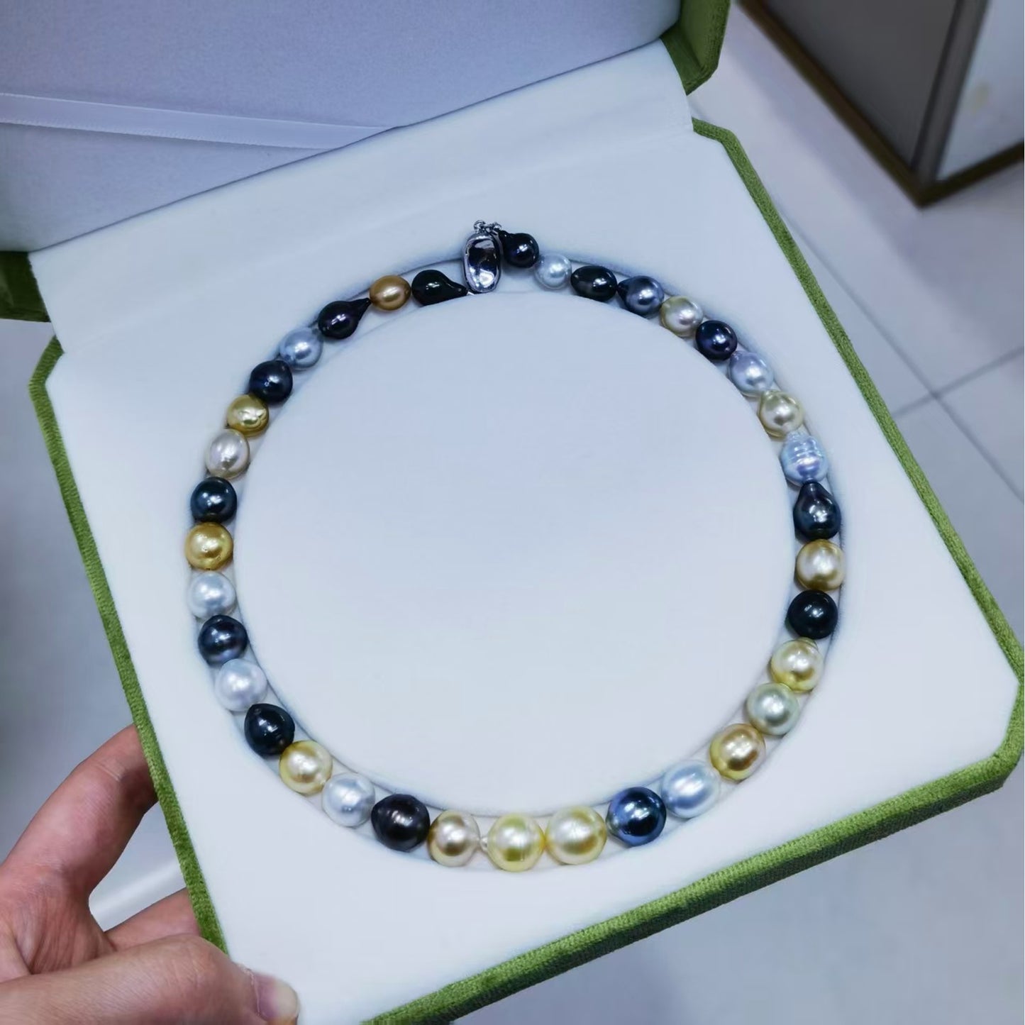 Finished mixed South Sea and Tahitian baroque pearl necklace in jewelry box showing natural color variation