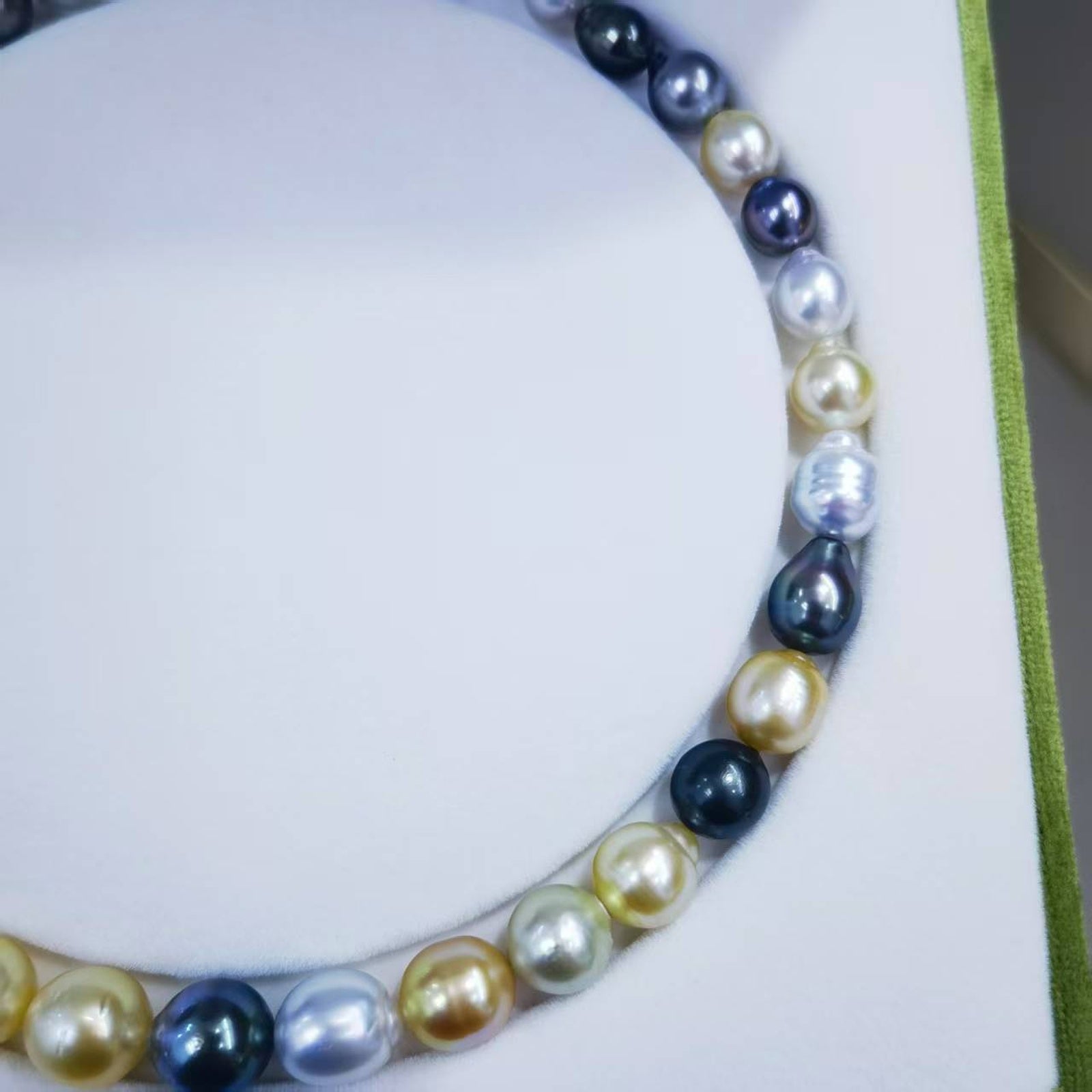Close-up of mixed South Sea and Tahitian baroque pearls showing luster, shape, and surface character