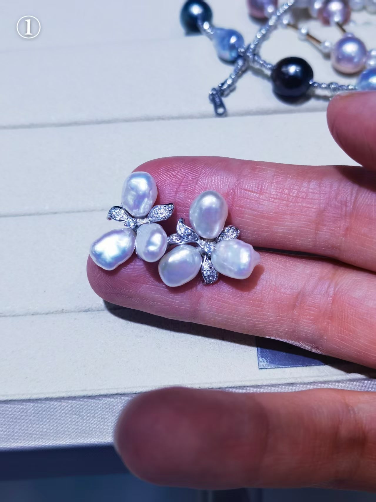 6–7mm baroque freshwater pearl earrings shown on finger for scale