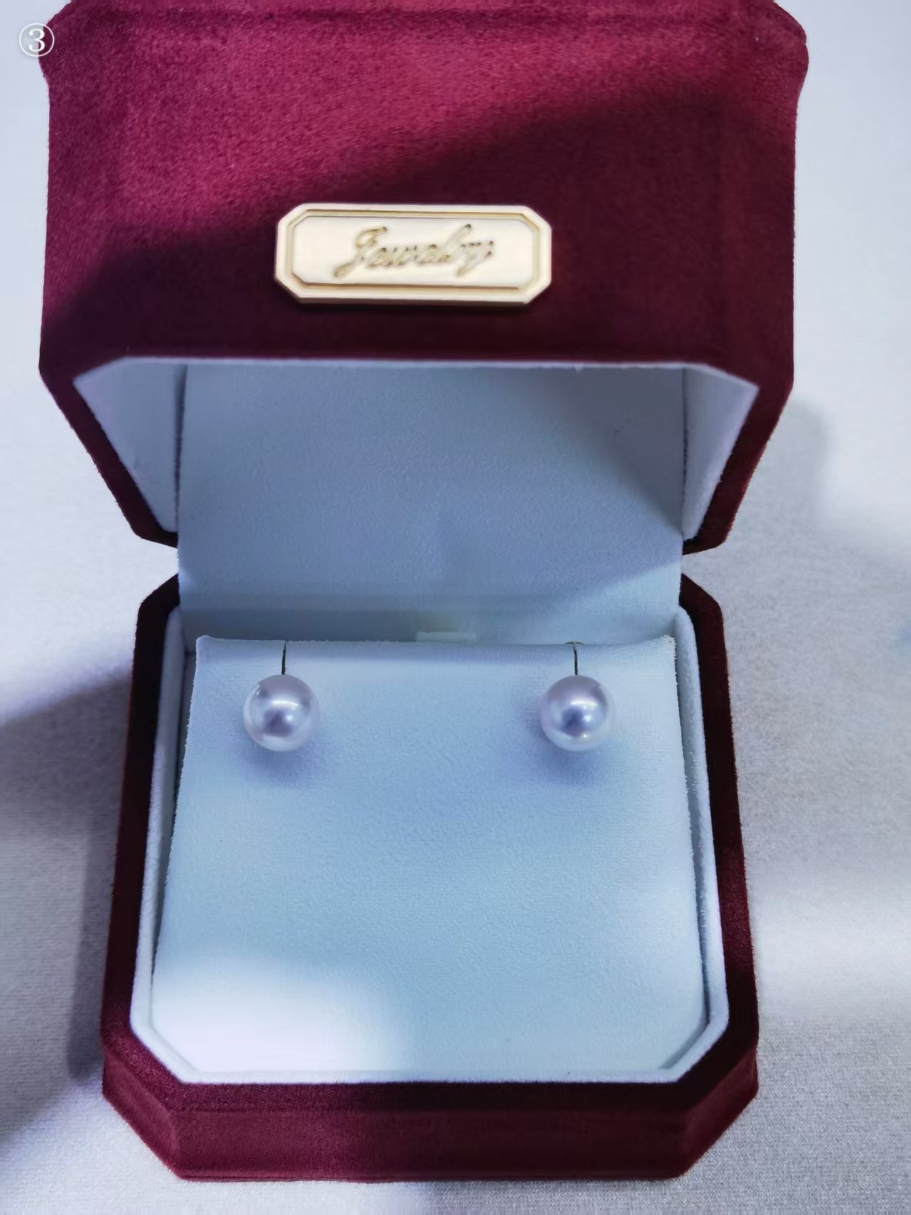 Close-up of 8–9mm white Akoya pearl stud earrings with clean surface and bright luster