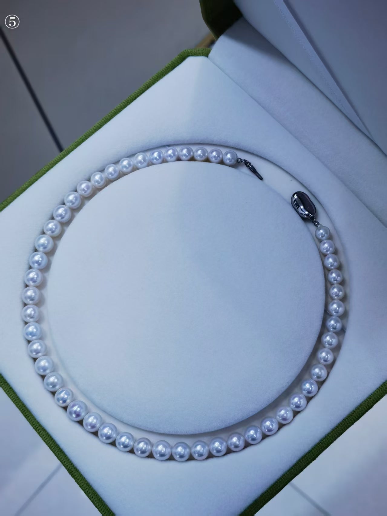 Exact white freshwater pearl strand necklace displayed in green jewelry box