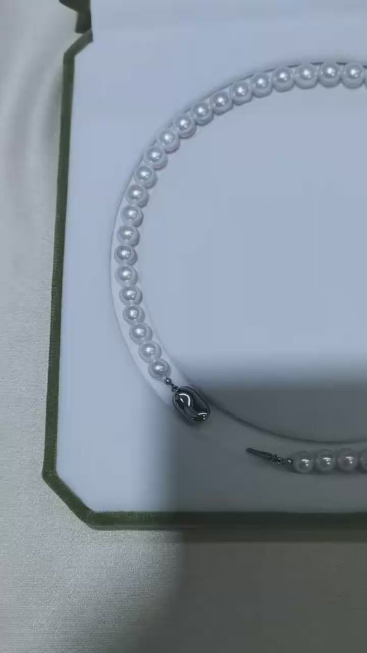 Video of exact 7–10mm white freshwater pearl strand necklace showing luster, shape, and clasp
